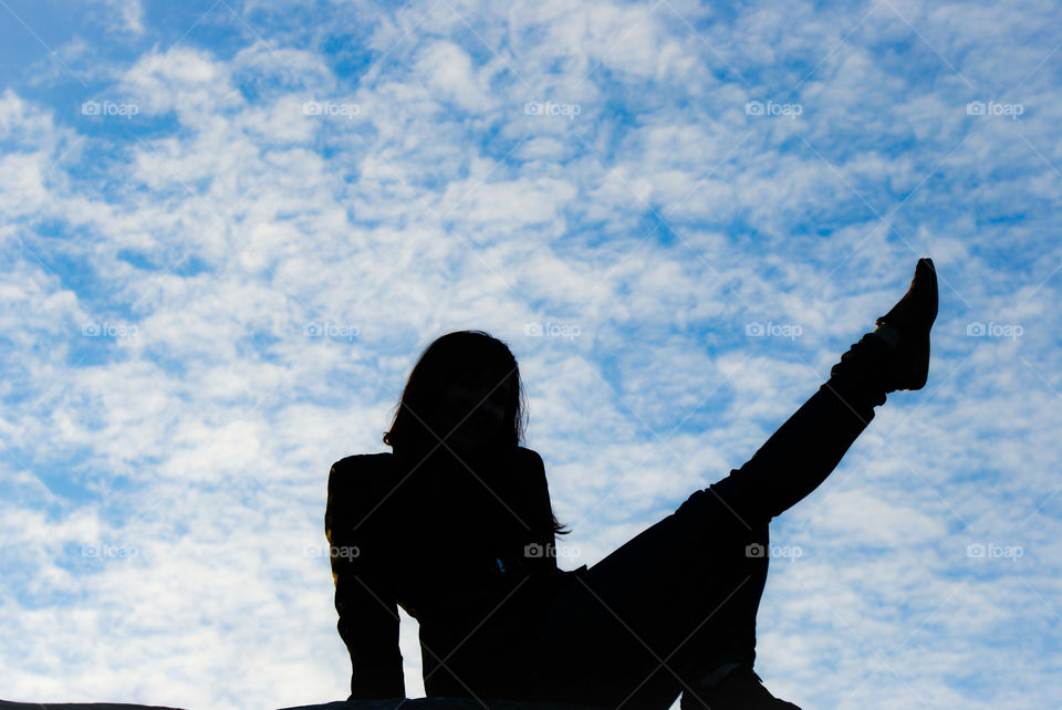 Silhouette of a girl on a sky background