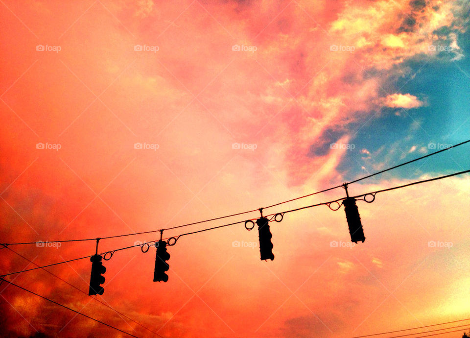 Traffic lights hanging on cable at sunset, Florida