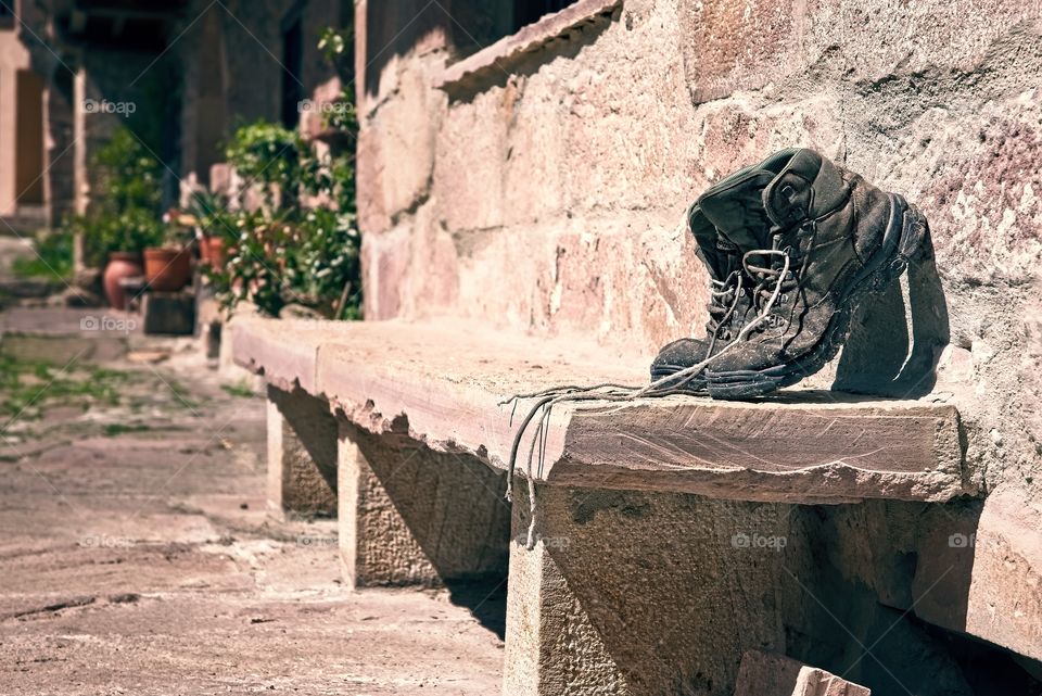 Old boots on a stone bench