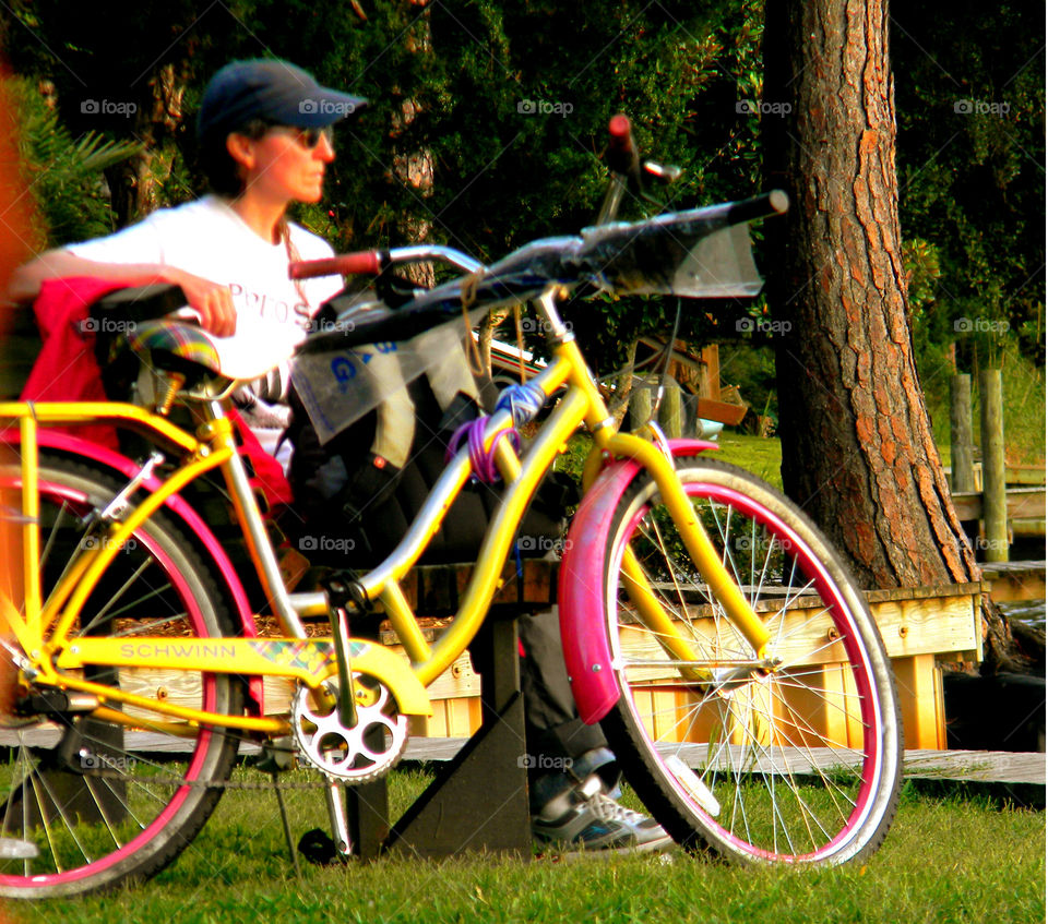 Pink and yellow bike. Lady with pink and yellow bike