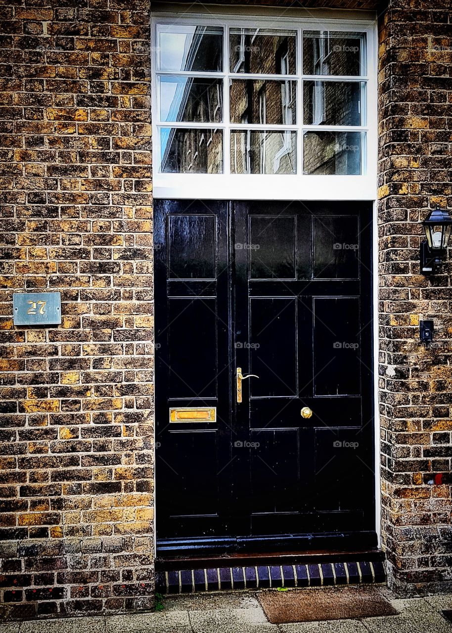 A door. Just a door. But a door to a building with so much history. Another historic building reflected above it...