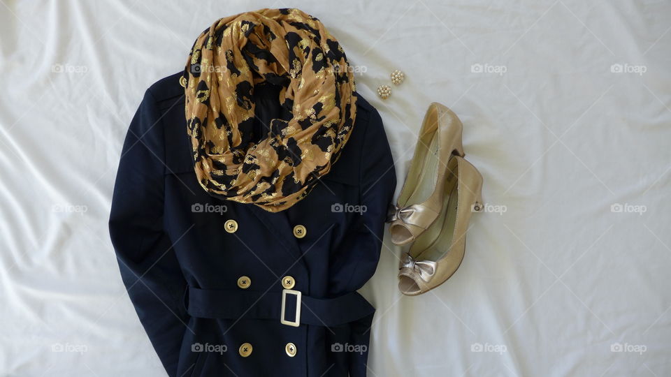 flat lay navy coat with gold deatil and god shoes and leopard scarf
