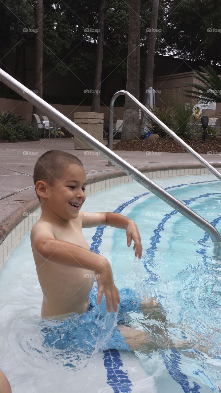 Small boy enjoying in swimming pool