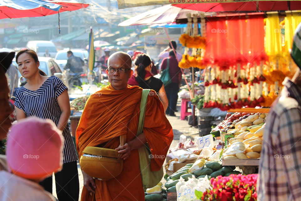 Monk on sidewalk at market Pattaya Thailand- January 2016