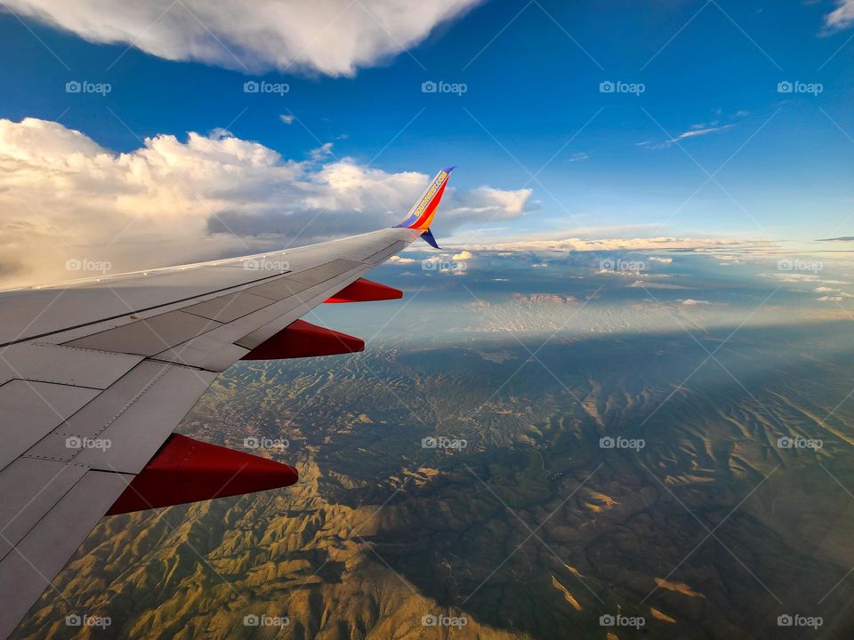 A Southwest Airlines Boeing 737 flies high above the Arizona desert as a monsoon storm starts to roll in