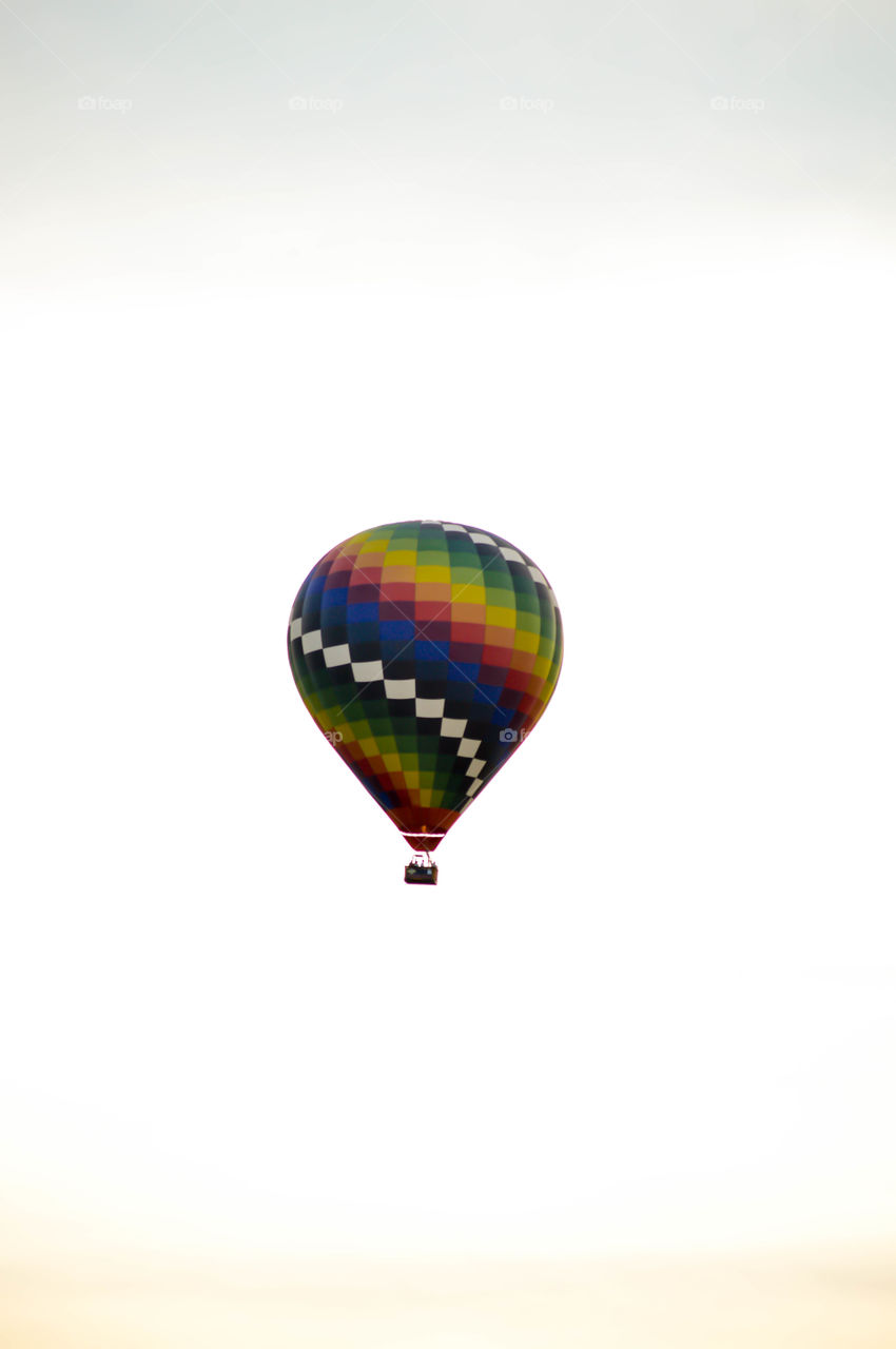 Rainbow colored hot air balloon in the sky