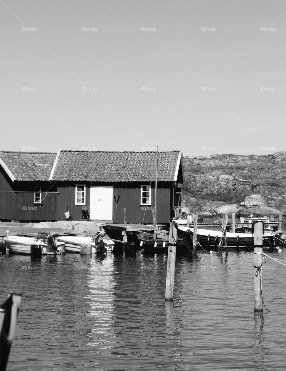 Black and White pic on boathouses near the sea