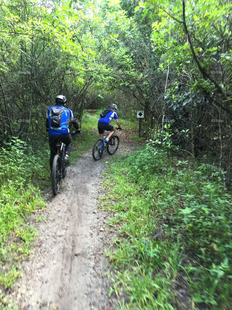 Biking. Men riding mountain bike on narrow dirt road