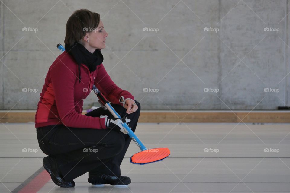 Curling. Female curling player during tournament in Zürich.