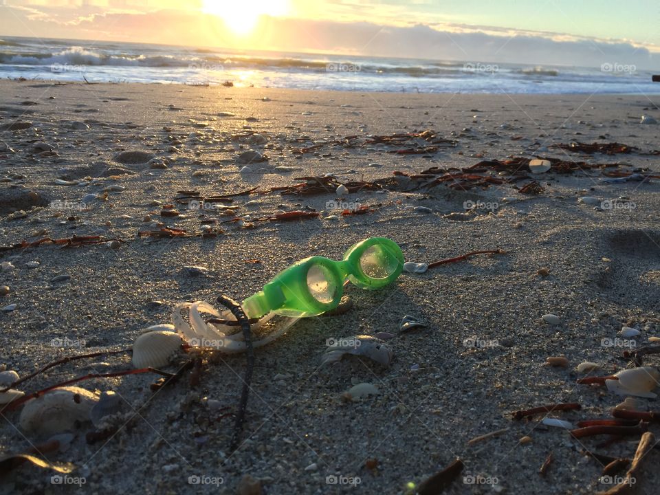 Goggles. Light. Beachcombing. Seashore. Beach find. Green. Sunshine. Summer. 