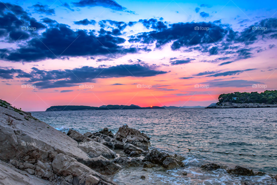 Sunset over rocky beach