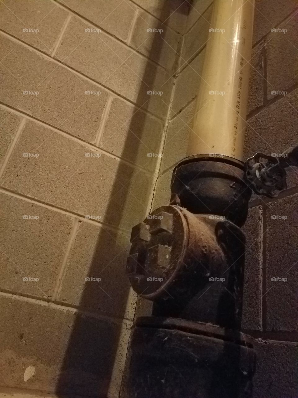 Water pipe with brick wall background