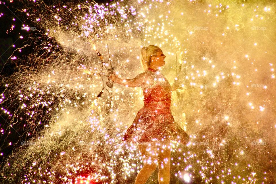 Mystical and magical twirling lights surrounding a young woman wearing a red dress 👗