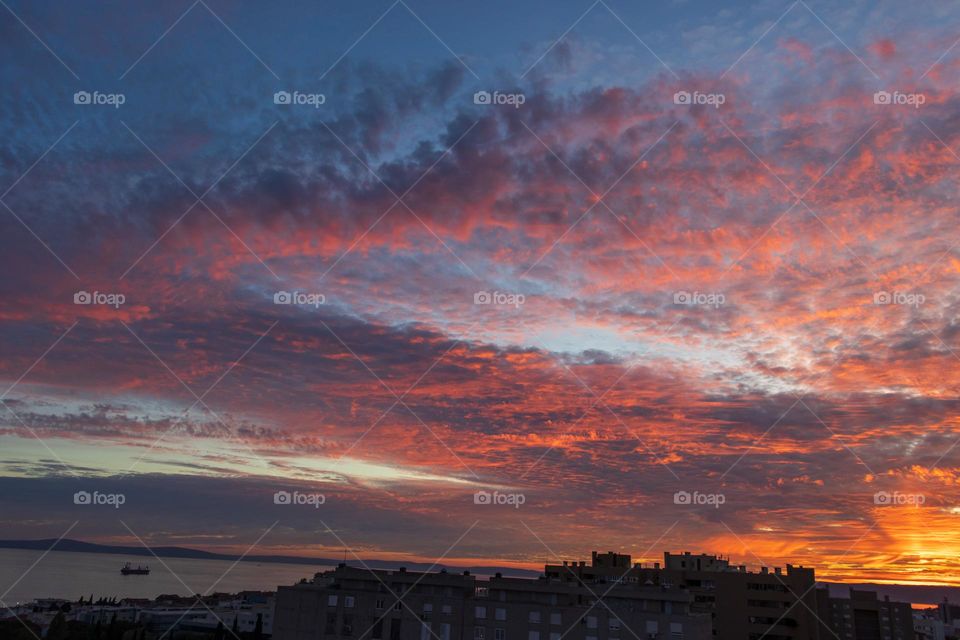 Incredible sunset and clouds coloured by sun in magenta color