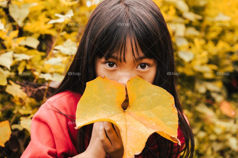 Fall season is a reminder that nothing lasts forever and we should embrace the changes in life, welcome the new beginnings. Portrait of a young little girl.