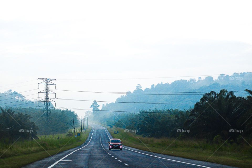Early morning journey with hazy hills as a background 