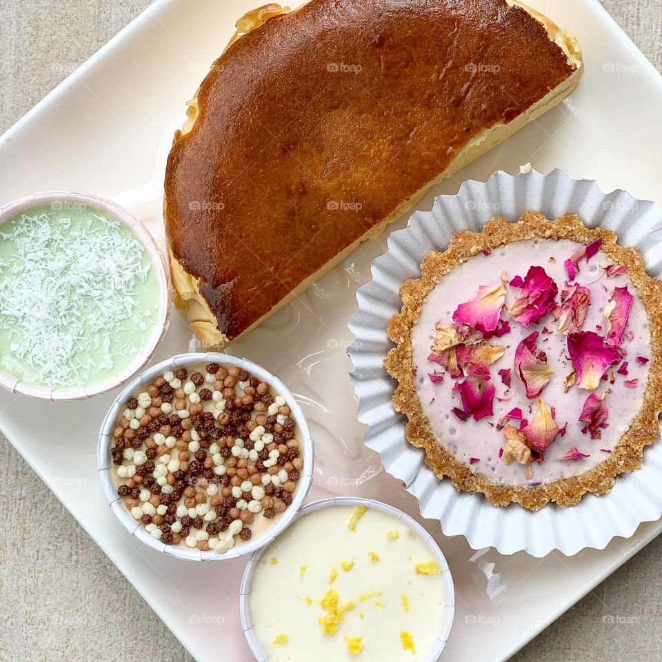 Omakase box of tofu tarts and tofu cups and basque burnt cheesecake in flatlay