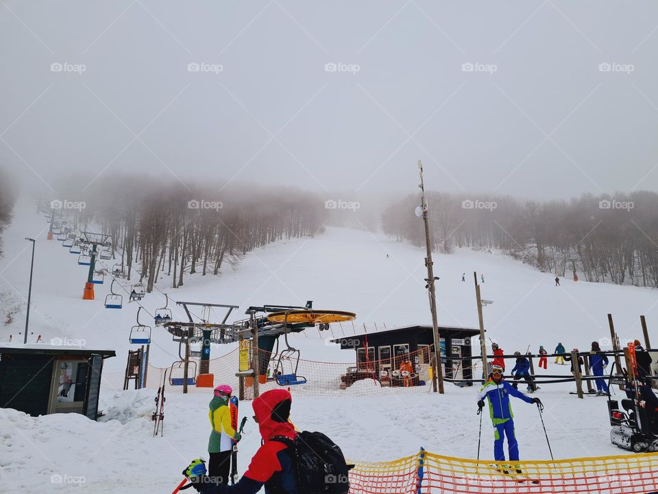 skiers queue for the ski pass