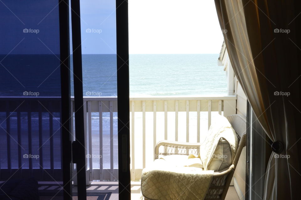 View of the ocean through an open window 