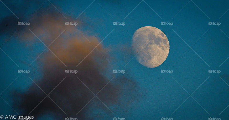 Close up of the moon with clouds
