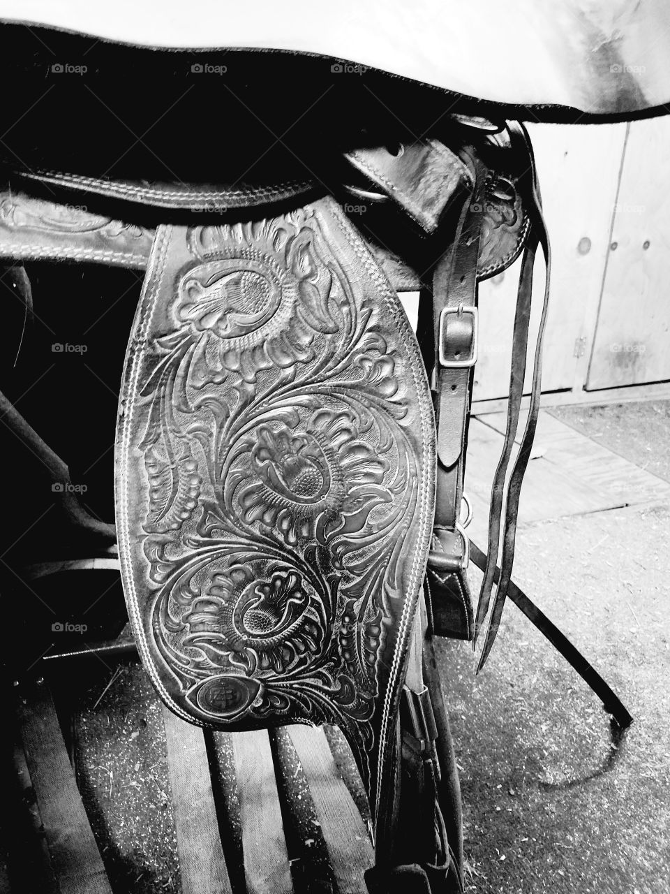 embossed leather work on a western saddle, black and white