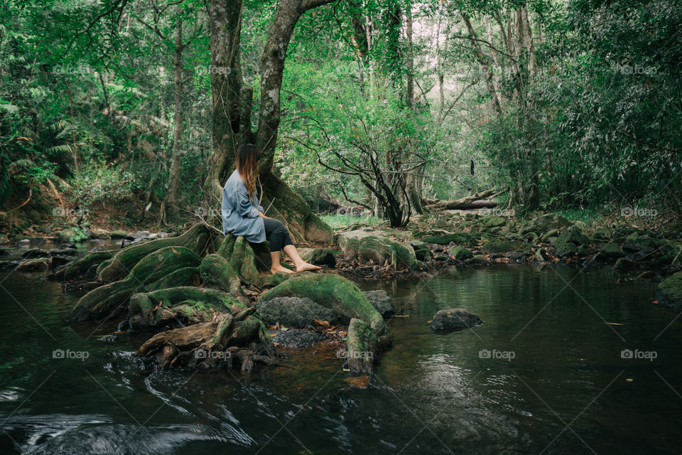 Female tourist girl in the forest pond