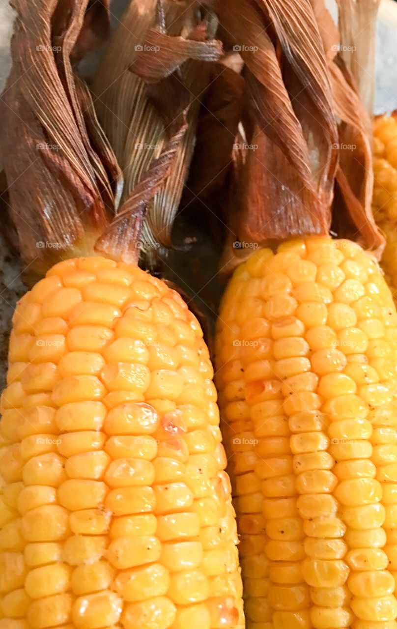 Close-up view corn on the cob corncobs  husk's husk yellow buttery delicious