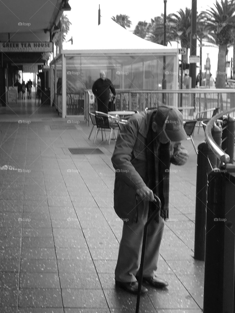 Elderly man with cane on Adelaide street