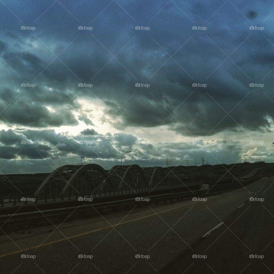 storm clouds over a field off the highway