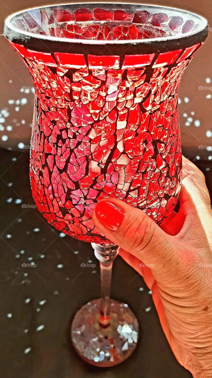 large wine glass held in the sunlight