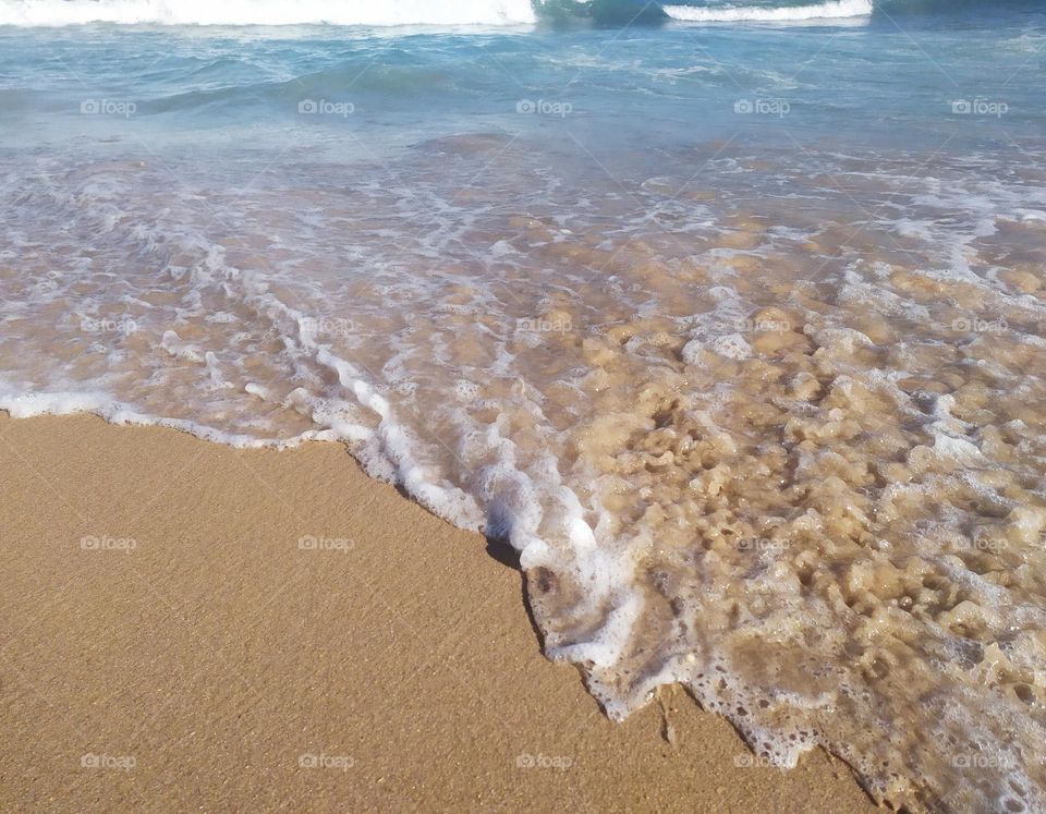 wave arriving in the sand