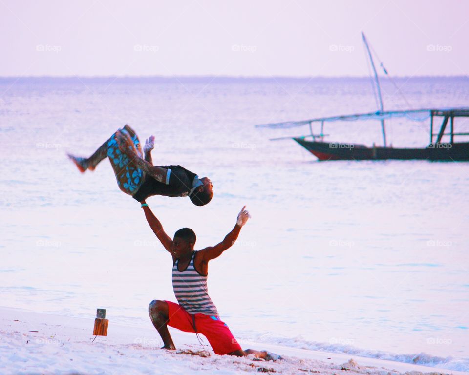 Acrobats on the beach. Zanzibar beach acrobatics. 