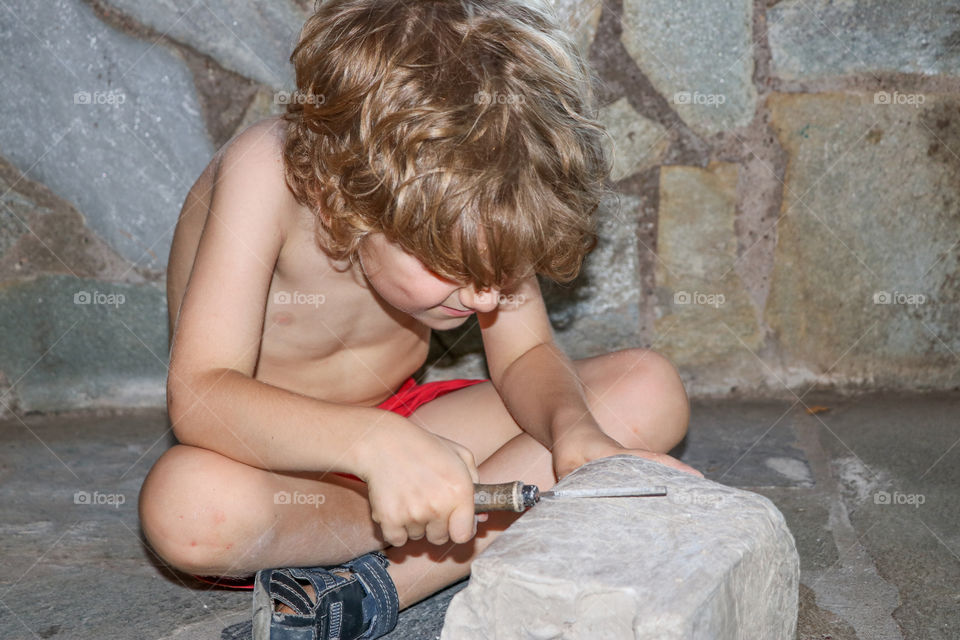 small child trying to sculpture