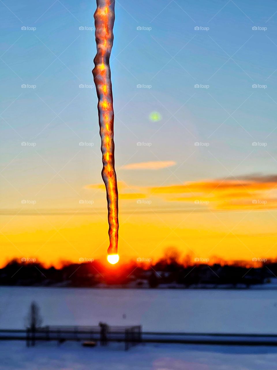 A winter day with some ice and the sunset on a cold Indiana day after some snow 