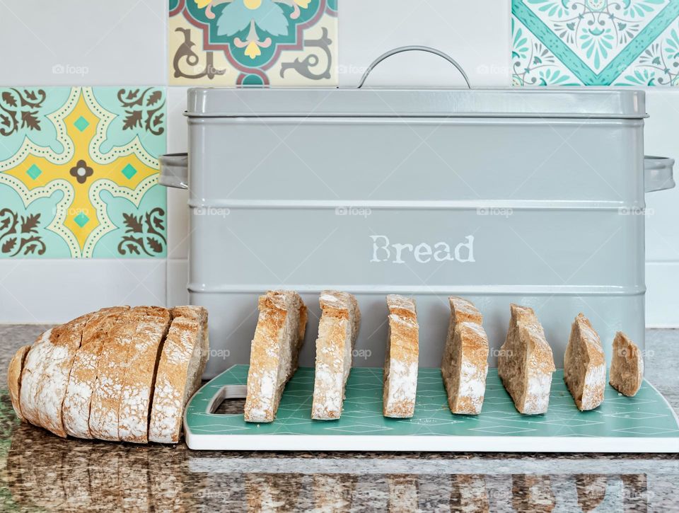 Fresh sliced white bread in a kitchen with Portuguese inspired tiles.