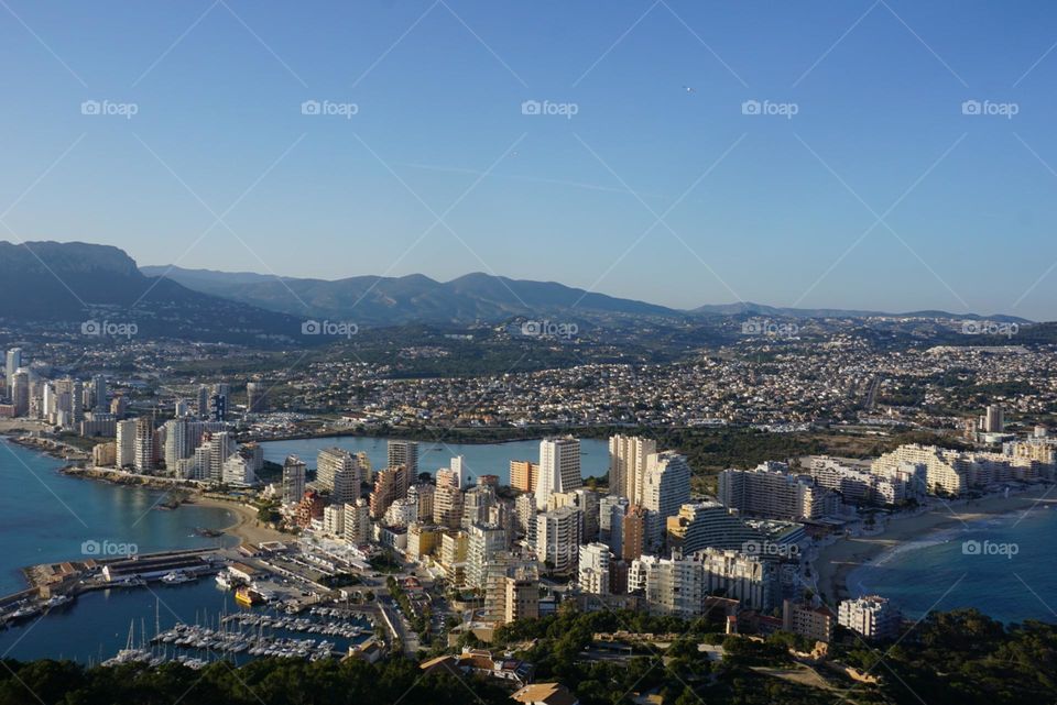 City#view#port#sea#buildings#boats#mountains