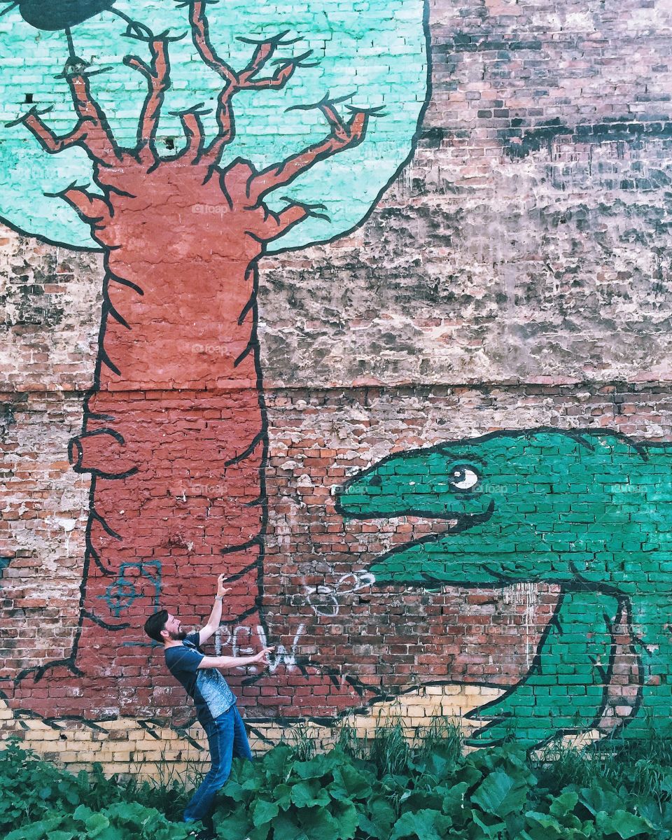 Man in front of wall mural