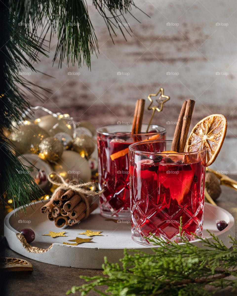 Two glasses of red punch with cinnamon sticks 