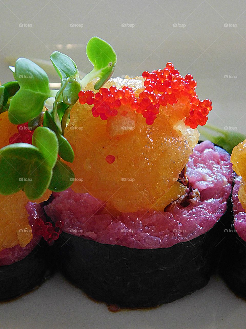 Colorful and very tasty Red Tuna Sashimi, rice , topped with Salmon Roe and watercress and ready to serve