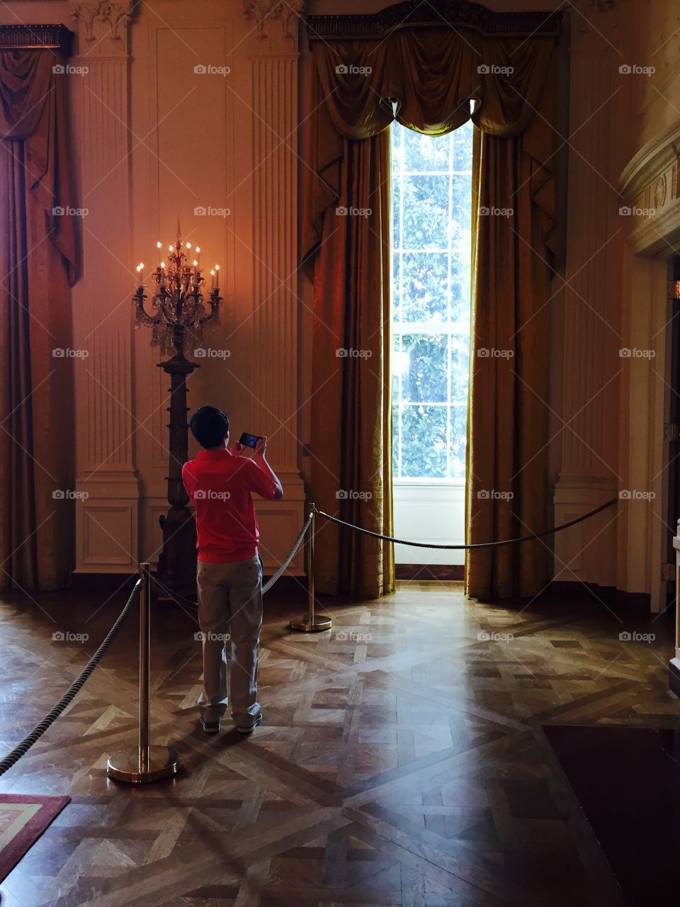 The White House photograph of a photographer at the window curtains