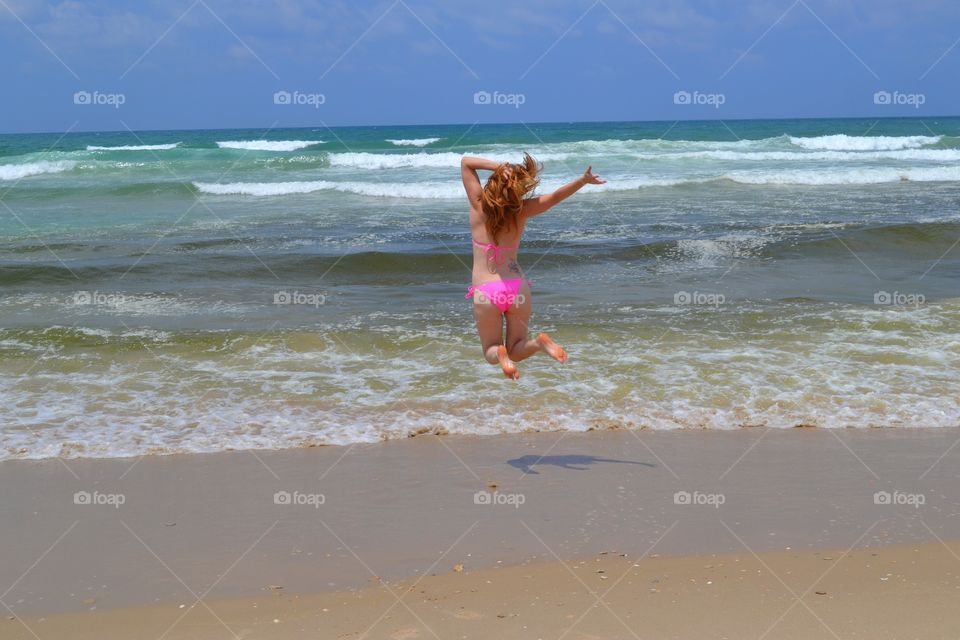 Jump of happiness at the beach