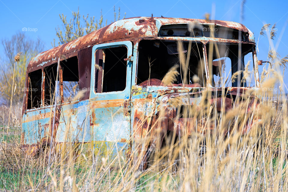 Old and abandoned Soviet Russian bus in the middle of reeds in rural Southern Armenia in Ararat province on 4 April 2017.