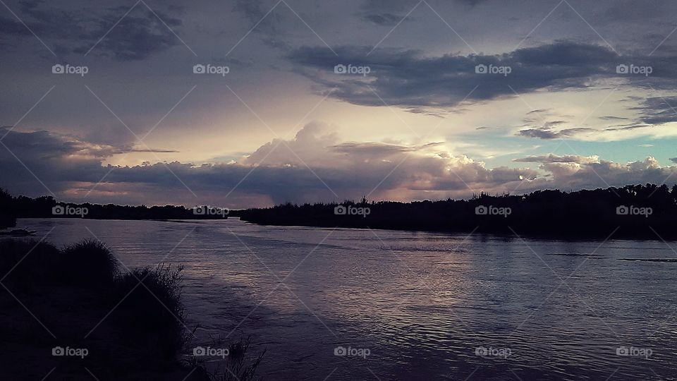 A post storm sky over a river in Texas, right before nightfall