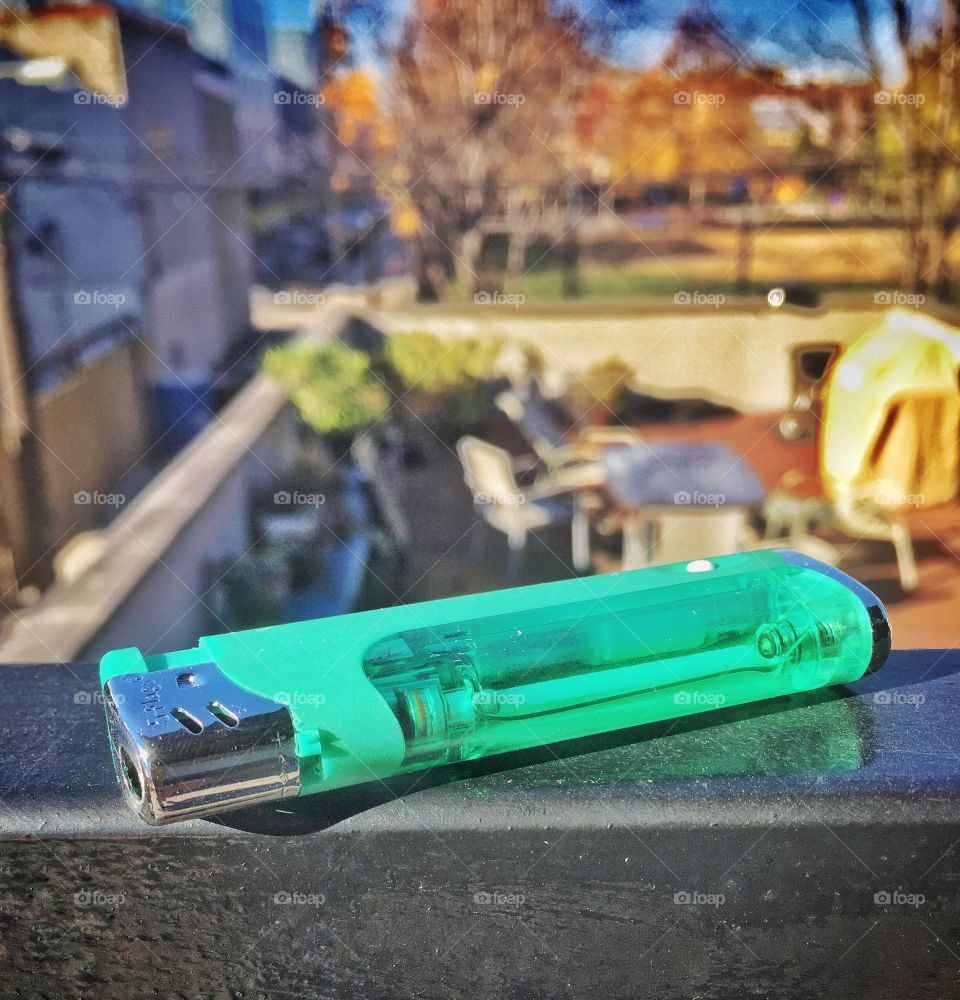 Green lighter with park in background