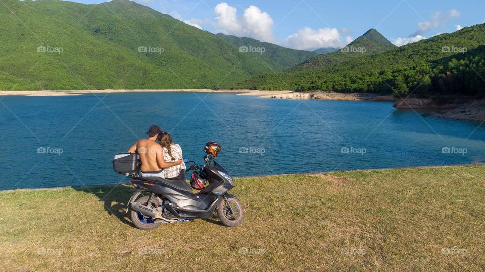 A couple enjoying the view of the lake 