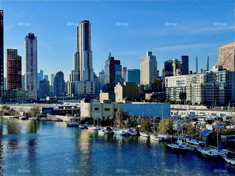 This is beautiful “Newtown Creek” seen from the “Pulaski Bridge” that connects “Greenpoint”, Brooklyn to LIC, Queens on a warm sunny Indian summer day in early November 2023. In the distance “Manhattan” can be seen. Hypnotic Productions