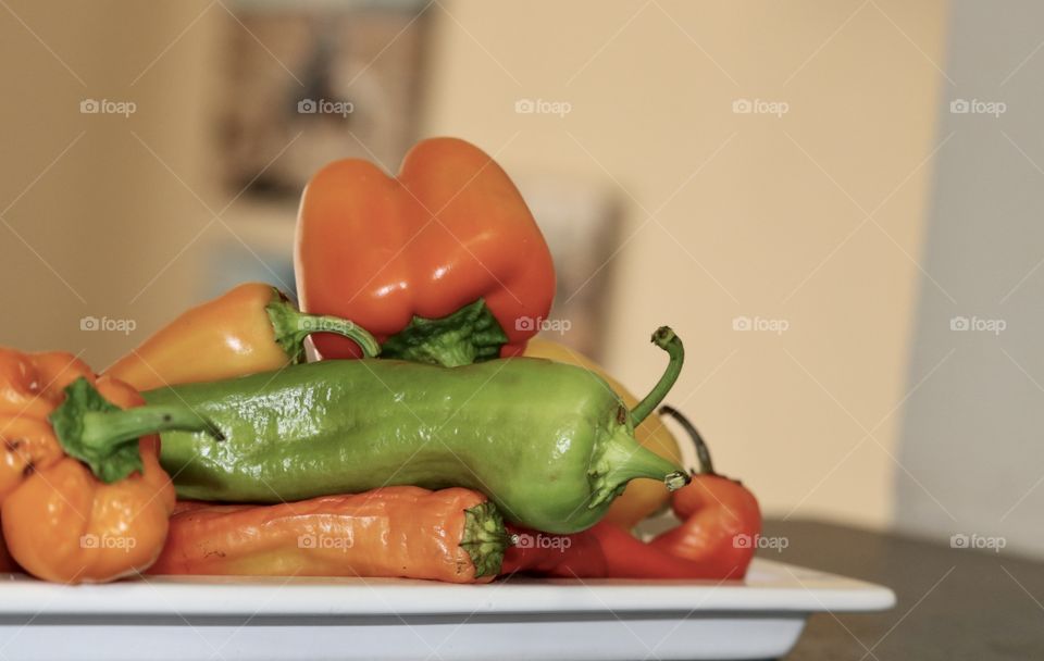 Orange variety of sweet bell
Peppers capsicum on white plate blurred background 