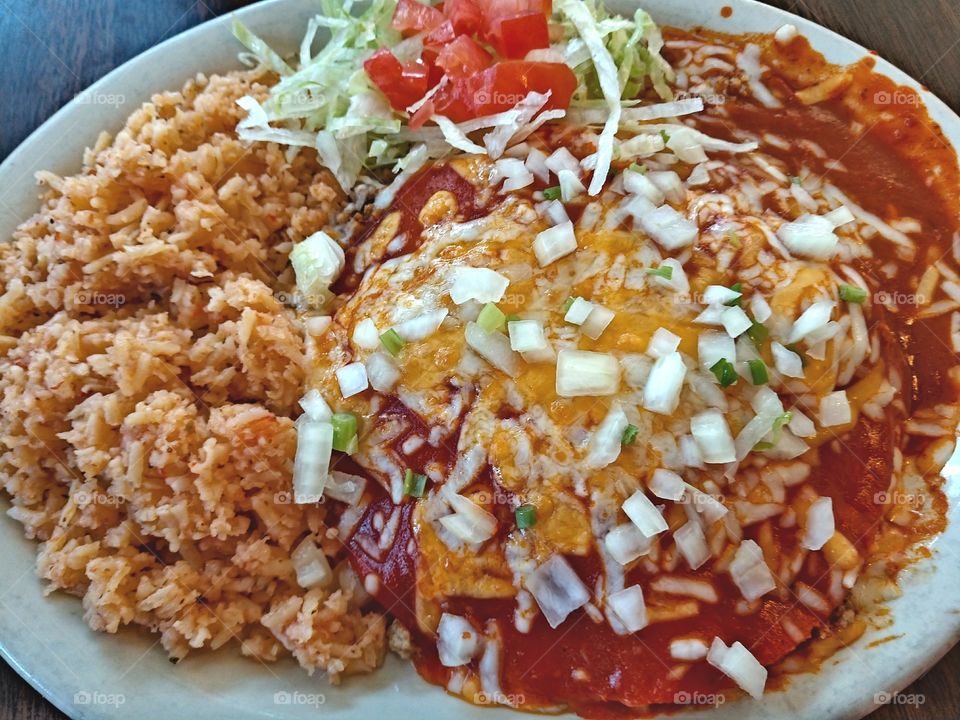 Beef enchiladas with rice, lettuce & tomatoes