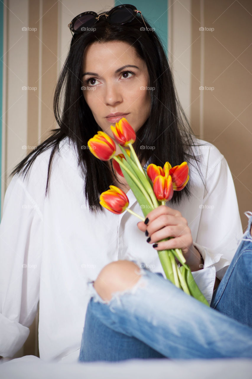 Young woman holding flower in hand