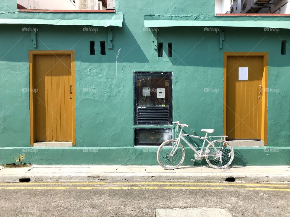 White bike vs green wall